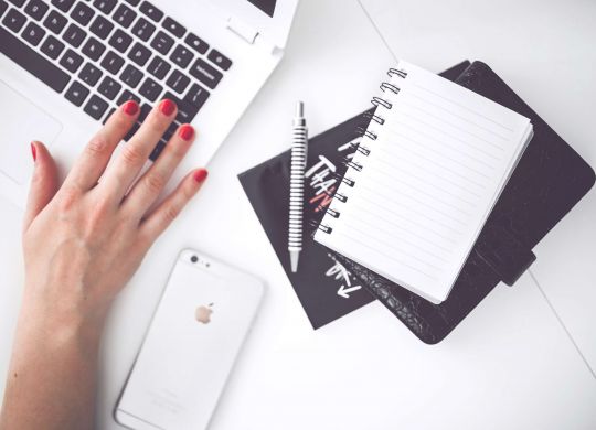 woman-hand-smartphone-desk